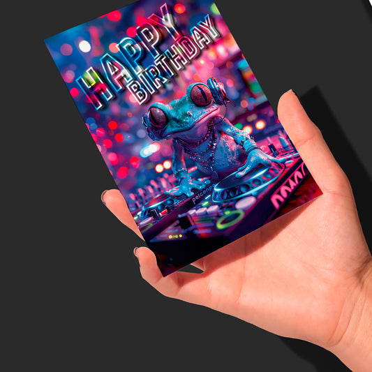 Rock On with this DJ Birthday Card&nbsp;
Get ready to leap into a world of fun with our DJ Birthday Card. This glossy-coated greetings card is like a party in the pond, featuring the groovy DJ-Frog ready to bring some amphibious excitement.

Make every card a hit! The blank inside lets you drop your own beats of creativity and it's supplied with a kraft envelope for easy posting or sharing. For music lovers.

• Card size 7x5"
• Blank Greeting card to personalise yourself
• Kraft Envelope